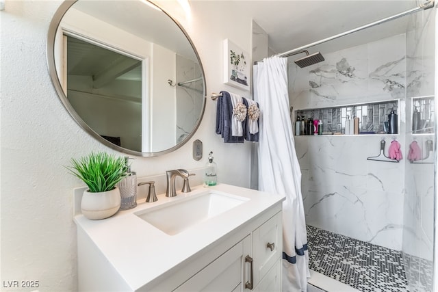 bathroom with vanity and a shower stall