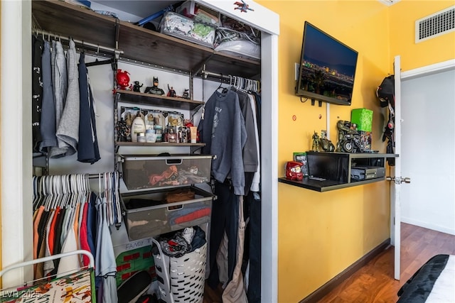 spacious closet featuring visible vents and wood finished floors