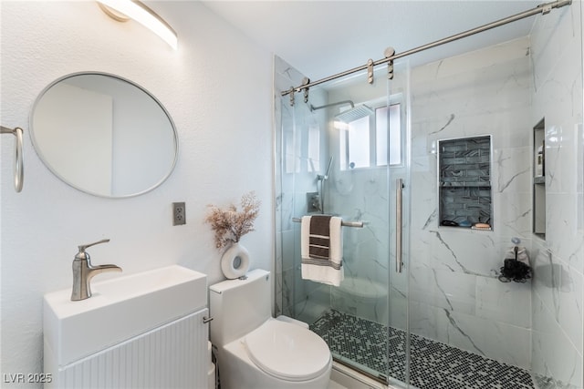 bathroom with a marble finish shower, toilet, and vanity