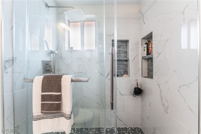 bathroom with a marble finish shower