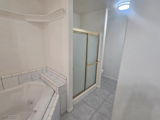 bathroom with a shower stall, tile patterned floors, a tub with jets, and toilet