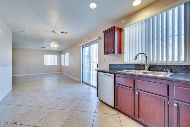 5854 Heather Marie Dr, Las Vegas, NV 89110 - kitchen with stainless steel dishwasher, a sink, reddish brown cabinets, light tile patterned floors, and recessed lighting