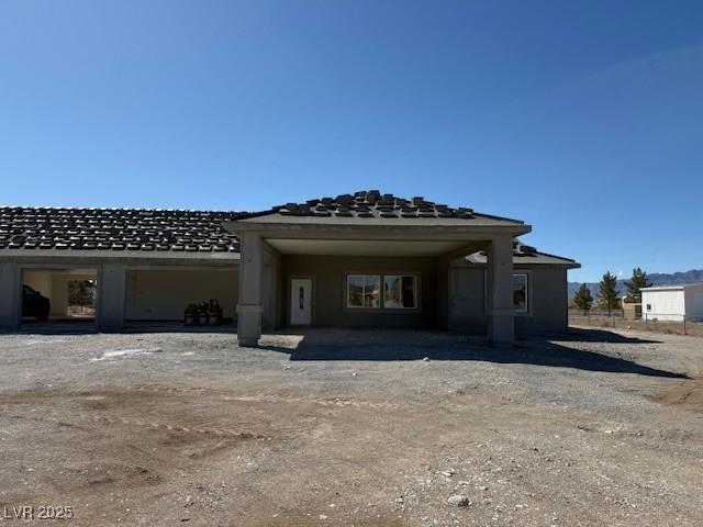 back of property featuring stucco siding