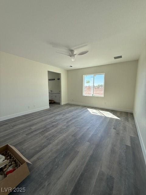 unfurnished bedroom featuring visible vents, wood finished floors, baseboards, and ceiling fan