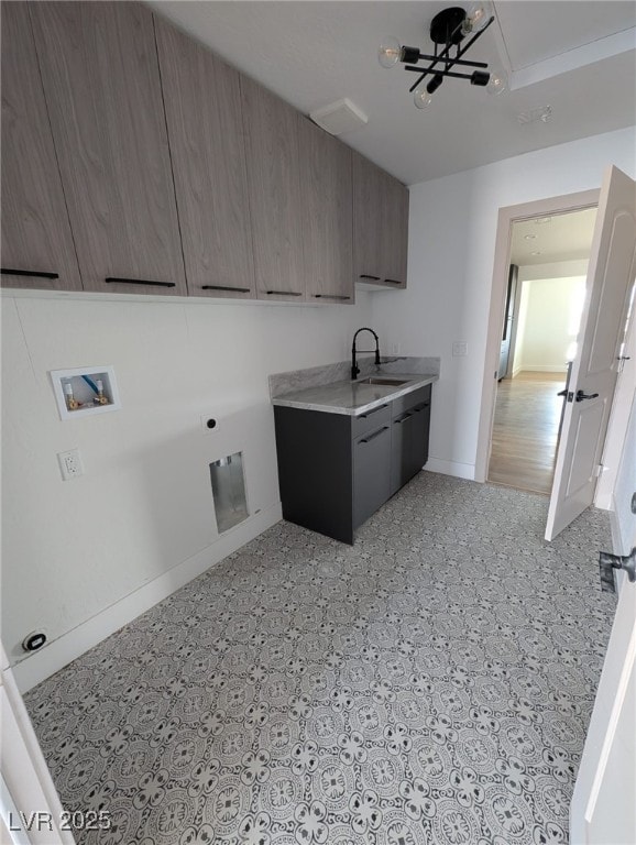laundry room featuring washer hookup, light floors, a sink, hookup for an electric dryer, and cabinet space