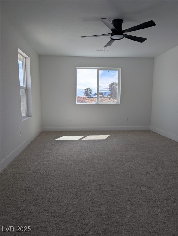 spare room featuring baseboards, ceiling fan, and carpet floors