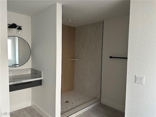 bathroom with baseboards and walk in shower