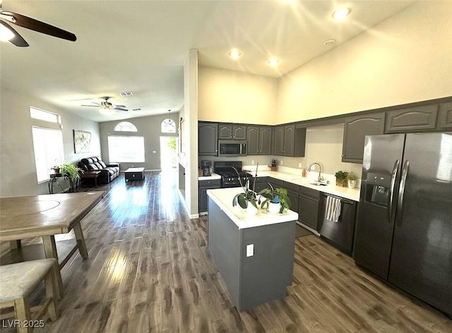 981 Leadville Meadows Dr, Henderson, NV 89052 - kitchen featuring stainless steel appliances, a ceiling fan, a sink, dark wood finished floors, and a kitchen island