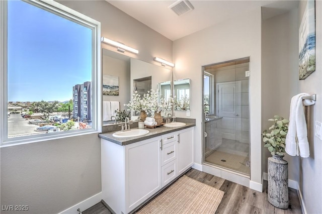 8629 Ensworth St Unit 114, Las Vegas, NV 89123 - full bath featuring double vanity, wood finished floors, and a shower stall