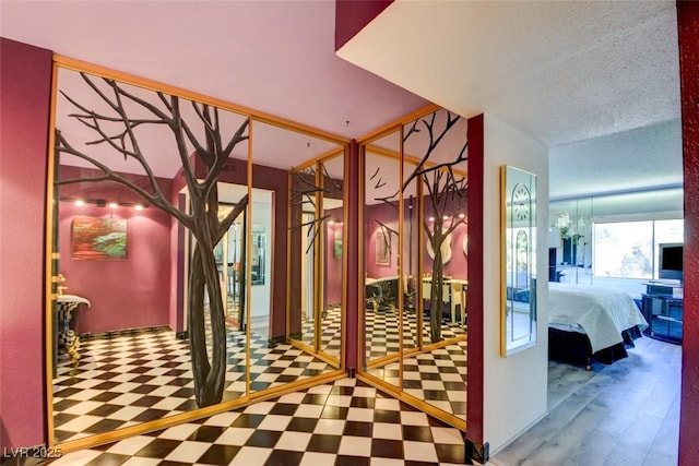 interior space with tile patterned floors and a textured ceiling