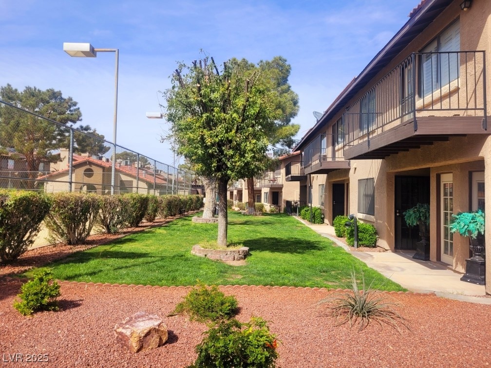 view of yard with a residential view and a balcony