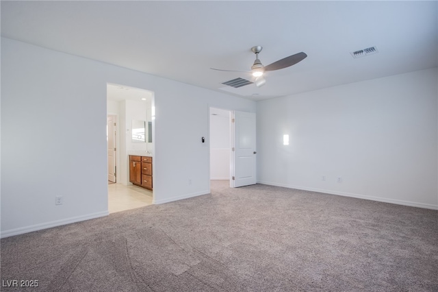 5748 Avondale Rise Way, Las Vegas, NV 89141 - unfurnished bedroom with light colored carpet, baseboards, connected bathroom, and ceiling fan
