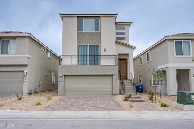 5748 Avondale Rise Way, Las Vegas, NV 89141 - view of front of house with stucco siding, a garage, decorative driveway, and a balcony