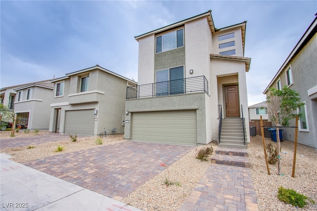 5748 Avondale Rise Way, Las Vegas, NV 89141 - multi unit property featuring stucco siding, a balcony, a garage, and decorative driveway