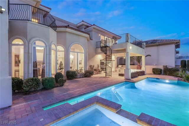 2660 Mirabella St, Henderson, NV 89052 - back of property featuring a balcony, a patio, an outdoor hangout area, stairs, and a pool with connected hot tub