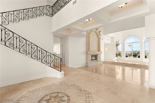 2660 Mirabella St, Henderson, NV 89052 - unfurnished living room featuring stairs, a tile fireplace, a towering ceiling, baseboards, and visible vents
