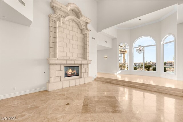 2660 Mirabella St, Henderson, NV 89052 - unfurnished living room with a high ceiling, marble finish floor, an inviting chandelier, visible vents, and baseboards