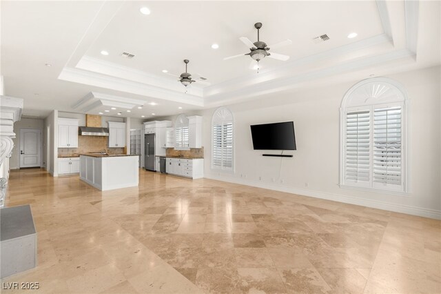2660 Mirabella St, Henderson, NV 89052 - unfurnished living room with a tray ceiling, visible vents, recessed lighting, ceiling fan, and crown molding