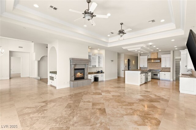 2660 Mirabella St, Henderson, NV 89052 - unfurnished living room with a tray ceiling, visible vents, and a ceiling fan