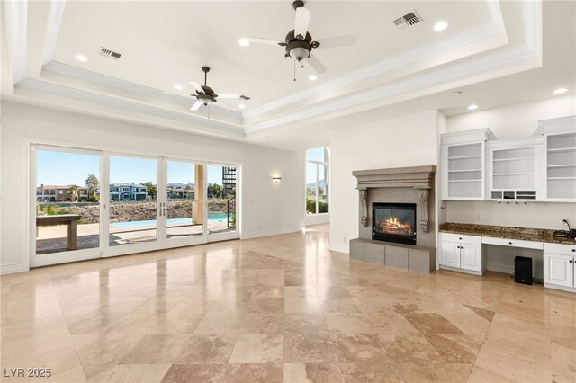 2660 Mirabella St, Henderson, NV 89052 - unfurnished living room featuring ceiling fan, a fireplace, baseboards, visible vents, and a raised ceiling
