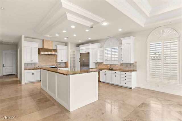 2660 Mirabella St, Henderson, NV 89052 - kitchen with stainless steel built in refrigerator, tasteful backsplash, recessed lighting, wall chimney range hood, and ornamental molding