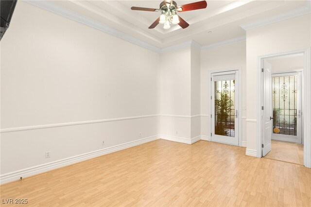 2660 Mirabella St, Henderson, NV 89052 - spare room featuring a tray ceiling, baseboards, light wood-style floors, ceiling fan, and crown molding