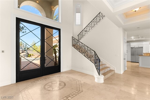 2660 Mirabella St, Henderson, NV 89052 - foyer featuring baseboards, a high ceiling, stairs, and ornamental molding