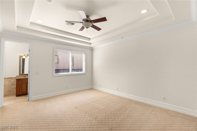 2660 Mirabella St, Henderson, NV 89052 - unfurnished bedroom featuring a tray ceiling, connected bathroom, recessed lighting, and light colored carpet