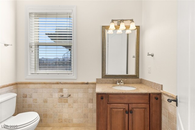 2660 Mirabella St, Henderson, NV 89052 - half bathroom featuring tile walls and a wainscoted wall