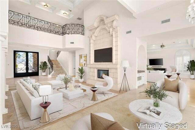 2660 Mirabella St, Henderson, NV 89052 - living room with a tiled fireplace, visible vents, a high ceiling, and stairway