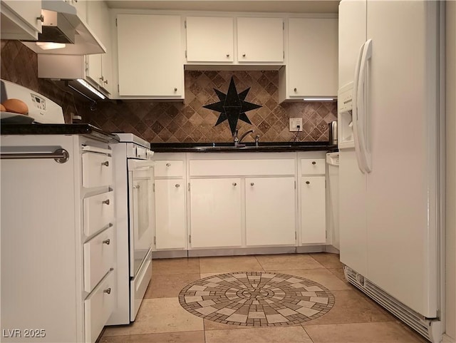 kitchen featuring dark countertops, decorative backsplash, under cabinet range hood, white fridge with ice dispenser, and light tile patterned floors
