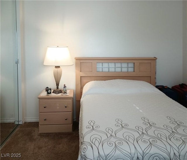 bedroom with dark colored carpet