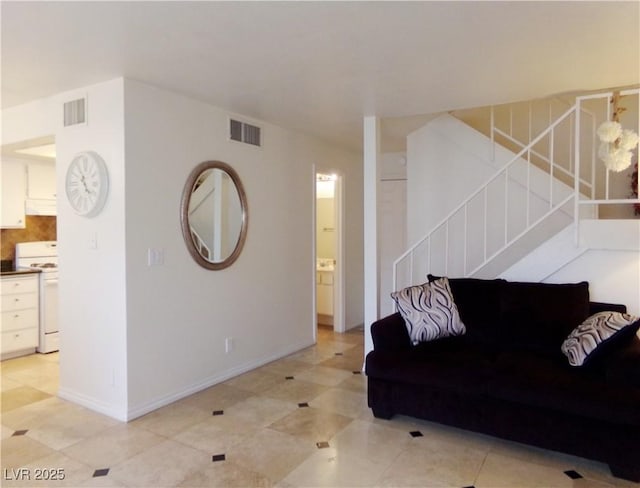 6412 Big Pine Way, Las Vegas, NV 89108 - living area with stairs, baseboards, and light tile patterned floors