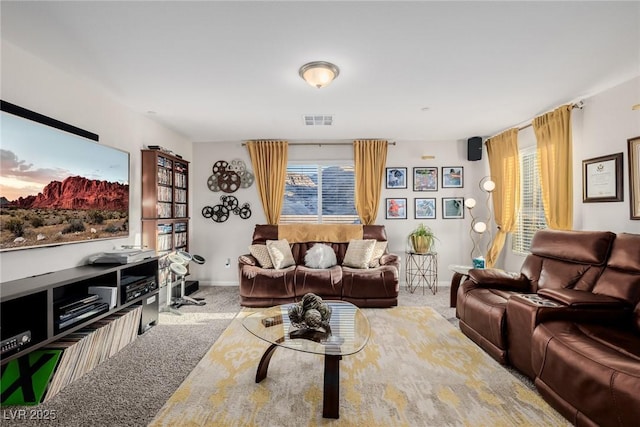 carpeted living room featuring visible vents, a healthy amount of sunlight, and baseboards