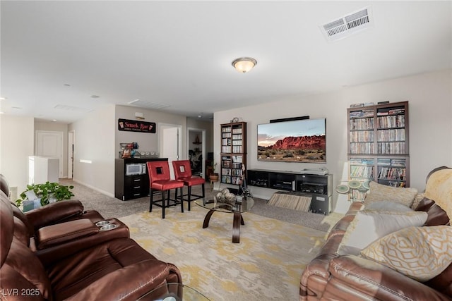carpeted living area with visible vents and baseboards