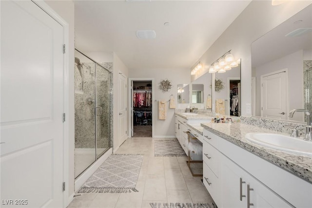 full bath featuring a sink, double vanity, and a shower stall
