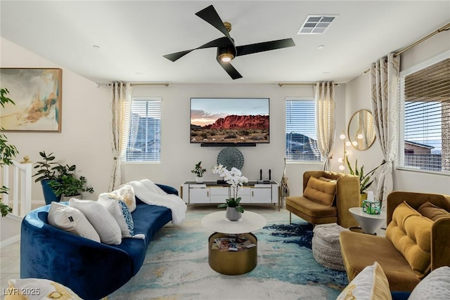living area featuring visible vents and a ceiling fan