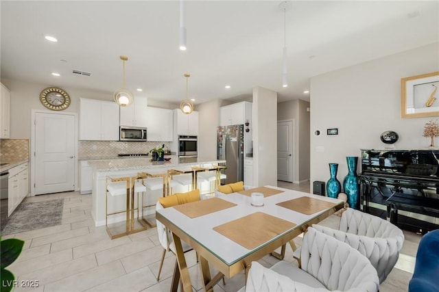 dining space with light tile patterned floors, recessed lighting, and visible vents