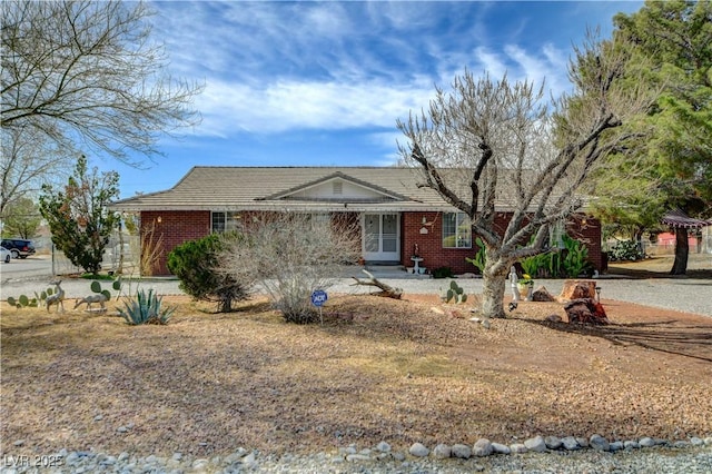 ranch-style home featuring brick siding