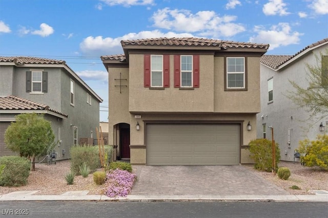 2945 Torreon Ln, Las Vegas, NV 89121 - view of front of house with a tiled roof, a garage, driveway, and stucco siding