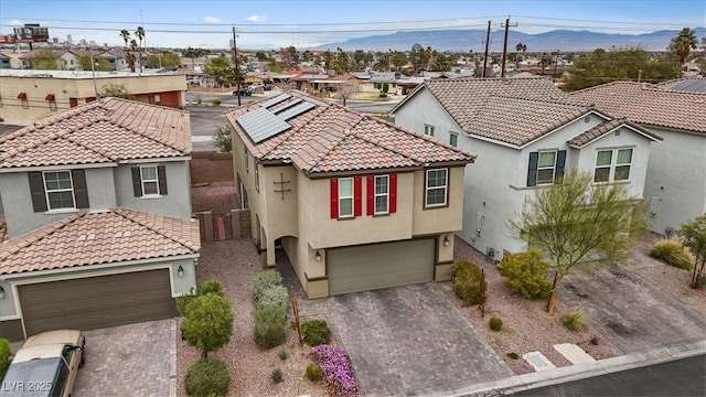 2945 Torreon Ln, Las Vegas, NV 89121 - mediterranean / spanish-style home with decorative driveway, a residential view, an attached garage, and stucco siding