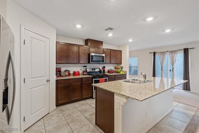 2945 Torreon Ln, Las Vegas, NV 89121 - kitchen featuring visible vents, recessed lighting, a kitchen island with sink, a sink, and appliances with stainless steel finishes