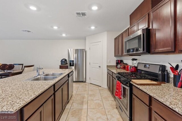 2945 Torreon Ln, Las Vegas, NV 89121 - kitchen featuring light tile patterned floors, visible vents, appliances with stainless steel finishes, and a sink