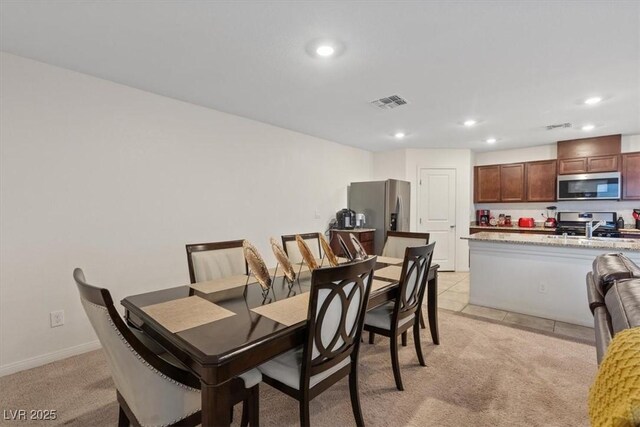 2945 Torreon Ln, Las Vegas, NV 89121 - dining space with recessed lighting, light colored carpet, visible vents, and baseboards