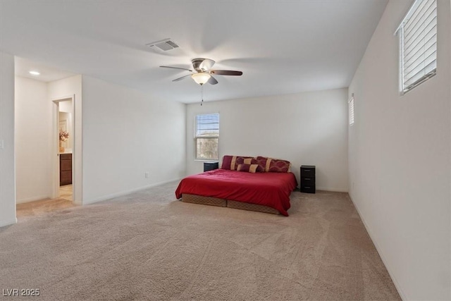 2945 Torreon Ln, Las Vegas, NV 89121 - bedroom with visible vents, light carpet, connected bathroom, and a ceiling fan