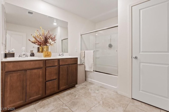 2945 Torreon Ln, Las Vegas, NV 89121 - full bath featuring double vanity, visible vents, combined bath / shower with glass door, and a sink