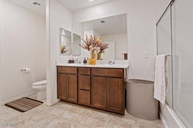 2945 Torreon Ln, Las Vegas, NV 89121 - bathroom featuring a shower with door, visible vents, toilet, and a sink