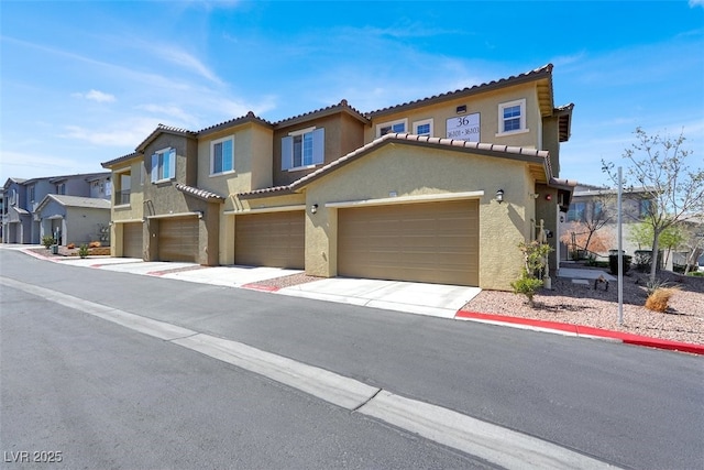 965 Nevada State Dr Unit 36102, Henderson, NV 89002 - view of front of property with a residential view, a tile roof, stucco siding, and a garage