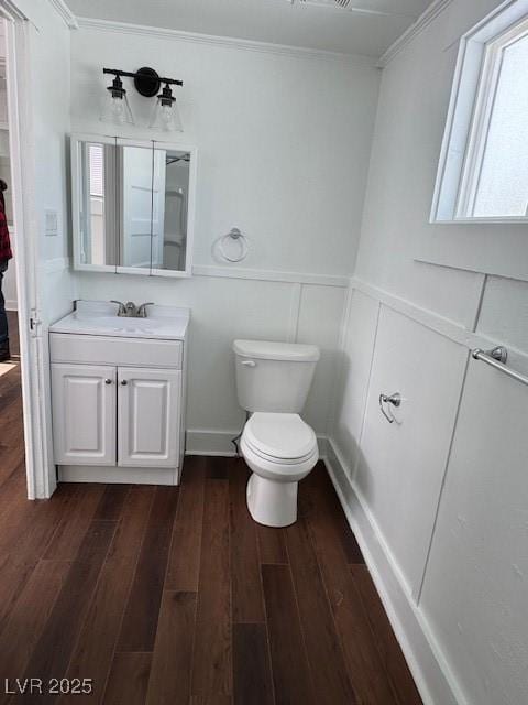 45 Keystone St, Ruth, NV 89319 - bathroom featuring crown molding, vanity, toilet, wood finished floors, and a decorative wall