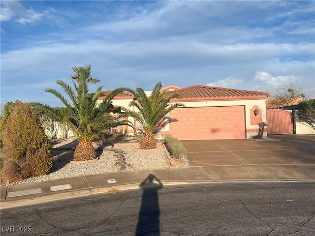 441 Daylin Ct, Henderson, NV 89015 - mediterranean / spanish-style house with a tiled roof, concrete driveway, stucco siding, a garage, and a gate